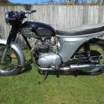 Triumph Speed Twin - 1964 - Left Side View, Headlight, Handlebars, Switches, Primary Chain Case, Kick Stand, Frame, Cables and Carburettor.